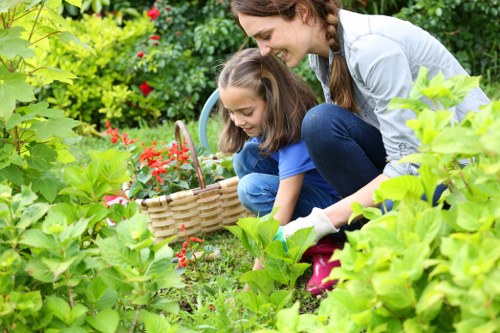 Staff member assisting a visitor at a community horticulture event in Barkingside.